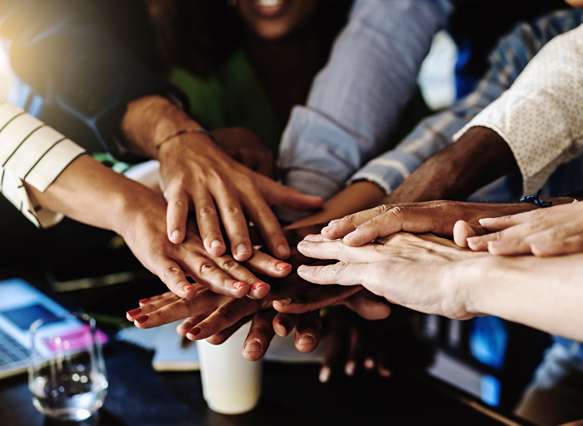 Community members joining hands in support of shared goals